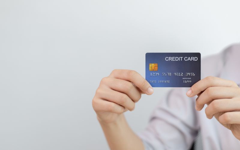 Hands holding a credit card